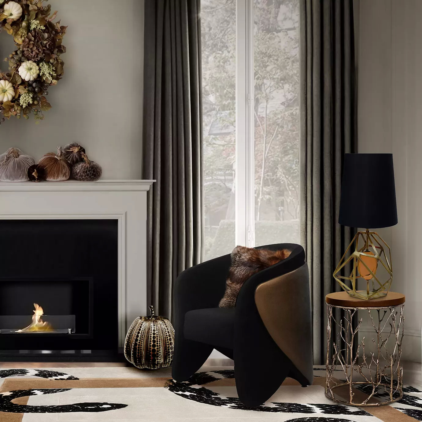 Cozy living room corner featuring the elegant Denise Chair upholstered in soft black fabric and a bronze-toned side panel, adorned with a textured brown cushion, next to a side table with a sculptural golden branch-like base and a wooden top, topped with a Table Lamp featuring a golden geometric base and a black lampshade, near a modern fireplace with an autumnal decoration of decorative pumpkins and a wreath on the wall, on a rug with an abstract pattern in beige and black tones, with grey curtains in the background and natural light from a window.