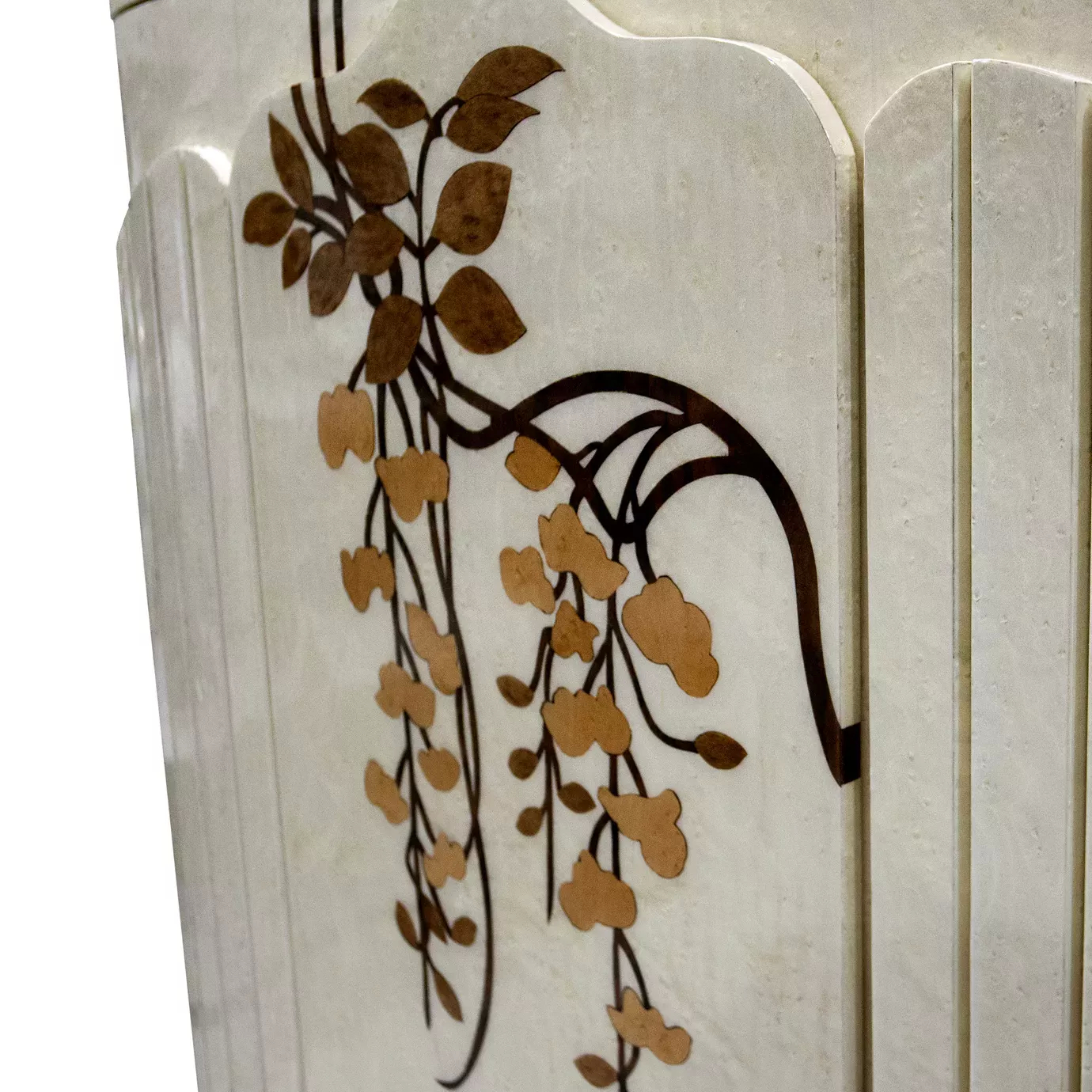 Elegant close-up detail of the delicate floral pattern in shades of brown and gold on the cream-white surface of the Fleur Nightstand.