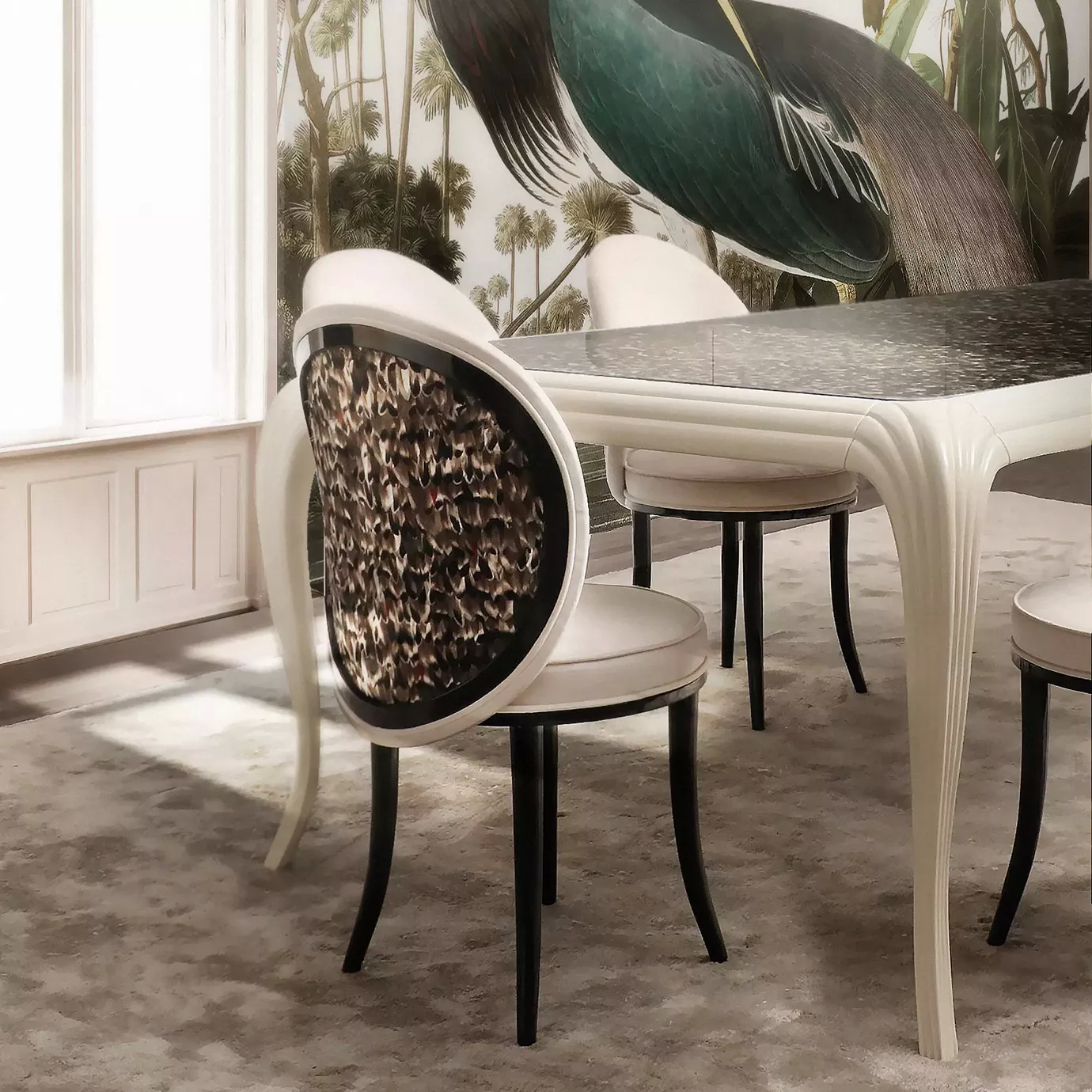 Elegant dining room with Merveille Folie Dining Chairs adorned with a brown and black feather pattern on the backrests, white upholstery, and black legs, around a dining table with a dark top and a curved white base, in a space with wallpaper featuring a tropical pattern with a large bird.