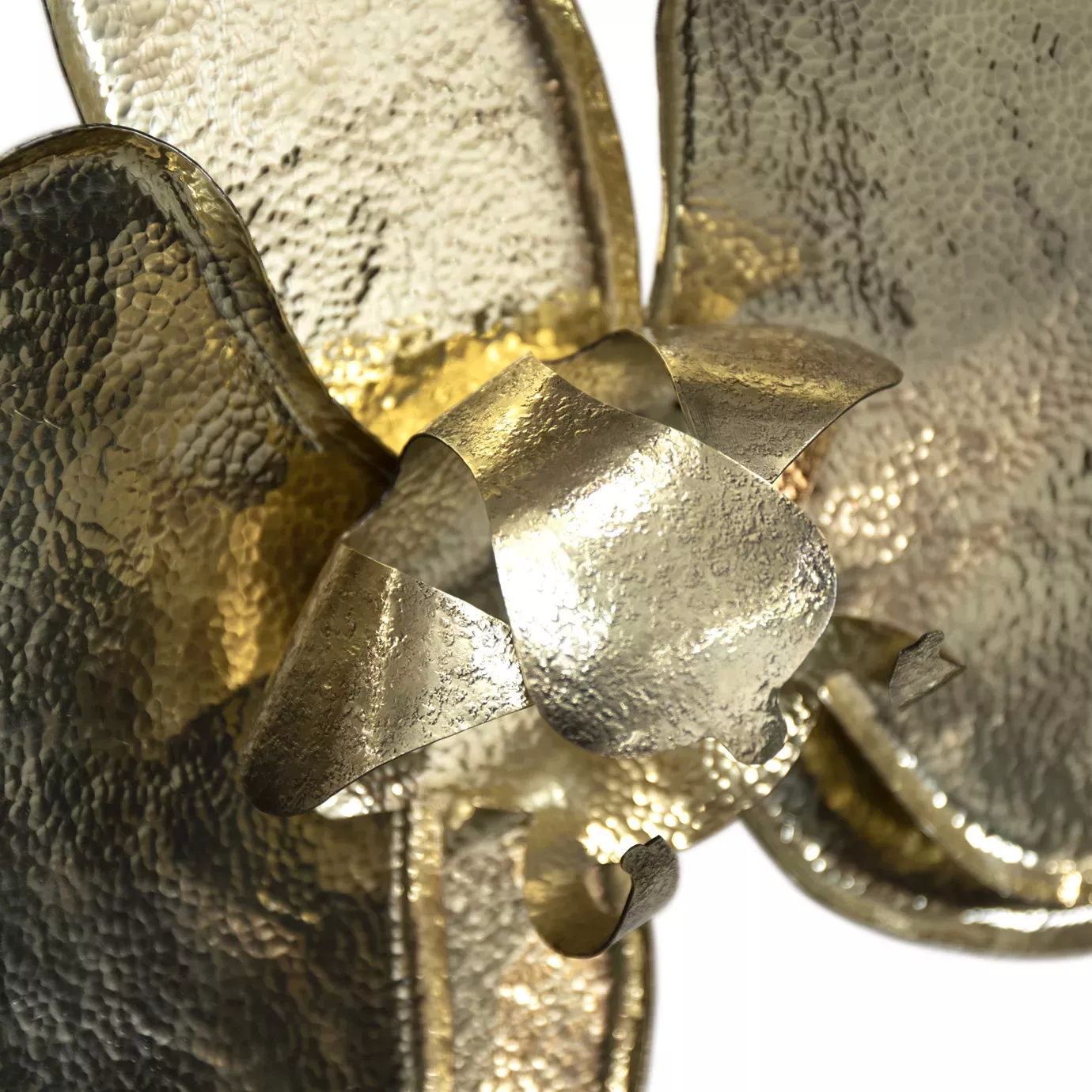 Delicate gold orchid brooch featuring hand-hammered details, displayed on a white background, embodying beauty and elegance.
