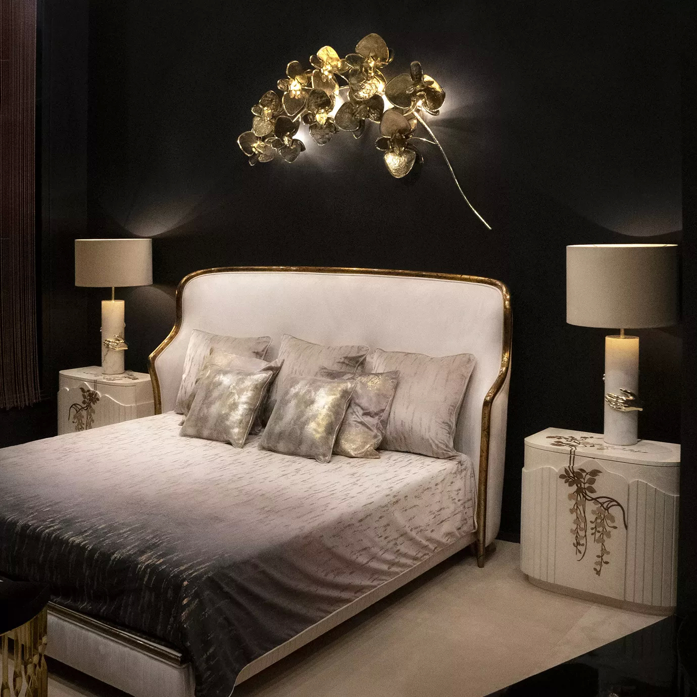 A modern bedroom showcasing gold and black walls, complemented by a bed in the center.