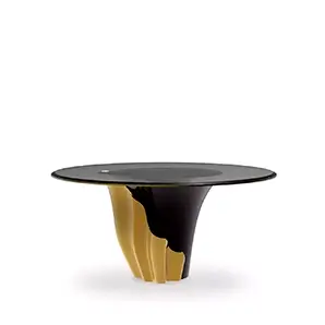 Yasmine Dining Table features a sultry silhouette with a smoked glass tabletop set on a solid wooden black base, adorned with a golden structure that arches back and forth.