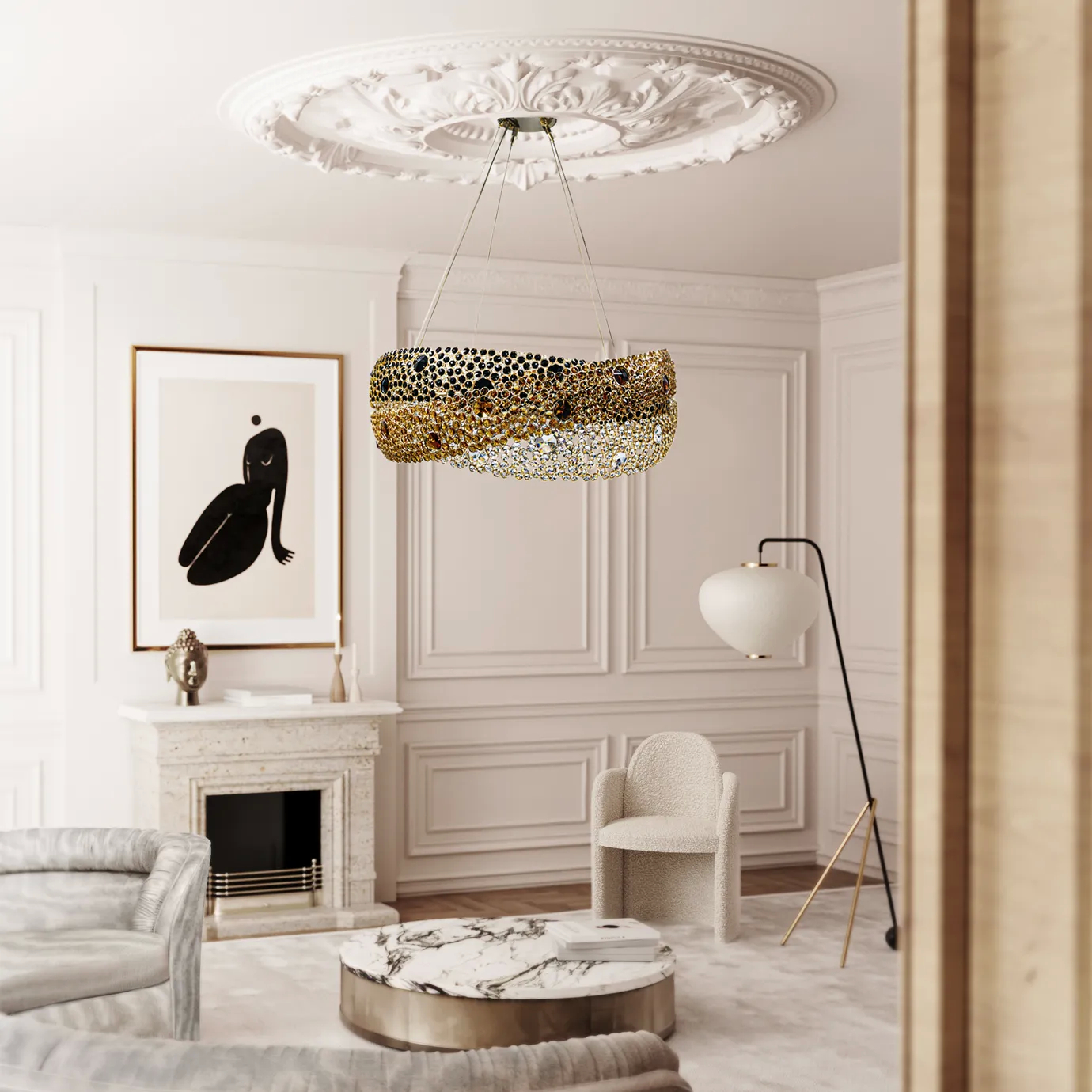 Elegant and bright living room featuring the Trinity Chandelier suspended beneath an ornate ceiling with a white rosette, centered in a space with white walls with decorative moldings, a white marble fireplace with a framed modern artwork above, a round coffee table with a white and gold marble top, a light textured sofa, a white boucle armchair, and a modern floor lamp with golden accents and a white shade.