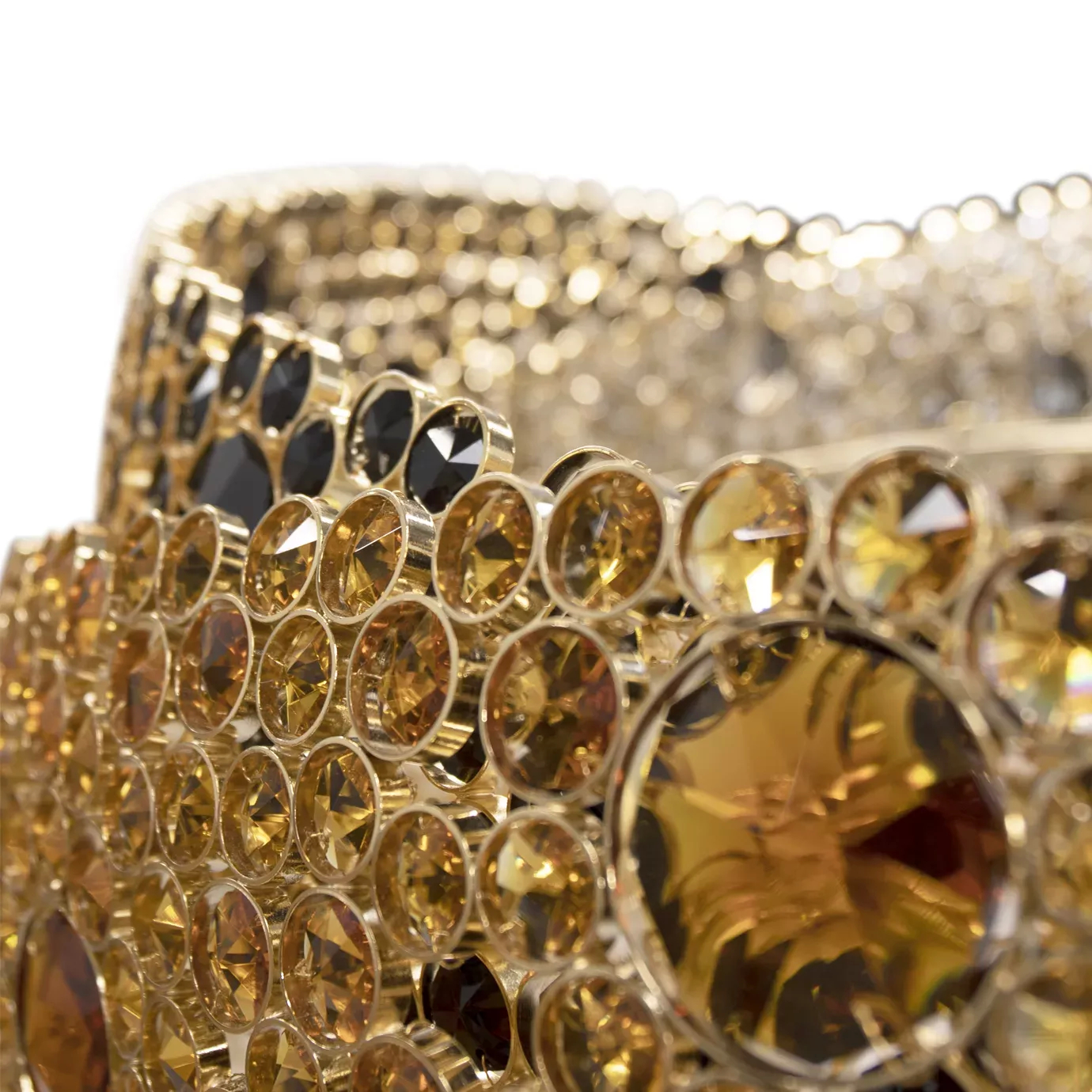 Elegant close-up detail of the golden crystals of varying sizes that adorn one of the undulating rings of the Trinity Chandelier.
