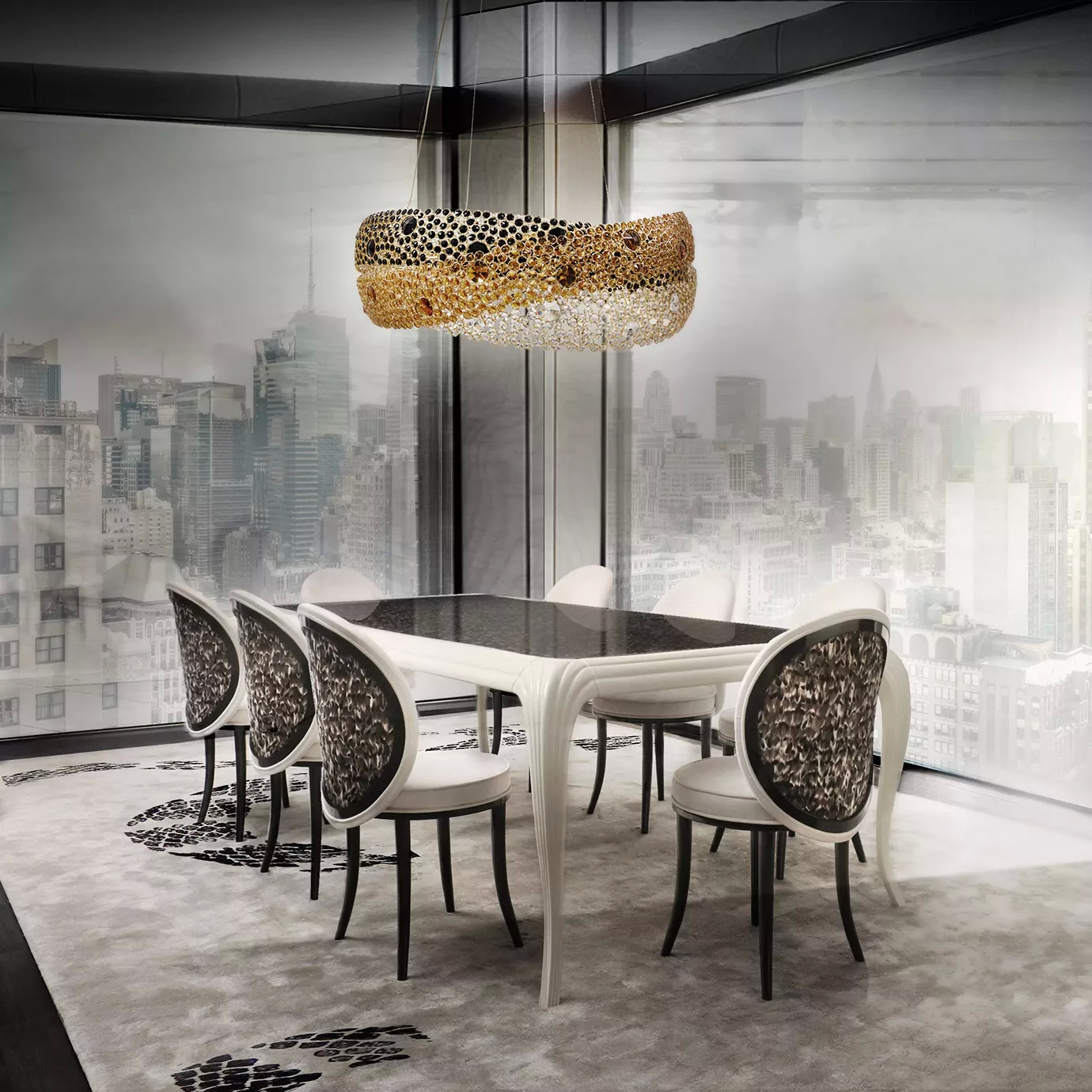 Elegant and modern dining room featuring the Merveille Dining Table with a dark top and a curved white base, surrounded by Merveille Folie Dining Chairs with backrests adorned with a brown and black feather pattern and white upholstery, beneath the Trinity Chandelier with rings of black, golden, and clear crystals, in a space with large windows overlooking a cityscape and a light rug with a black and white abstract pattern.