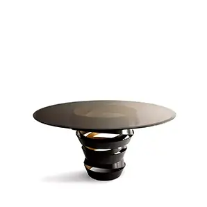Intuition Dining Table: Smoked glass tabletop on a swirling two-tone metal structure, black on the outside and golden on the inside.