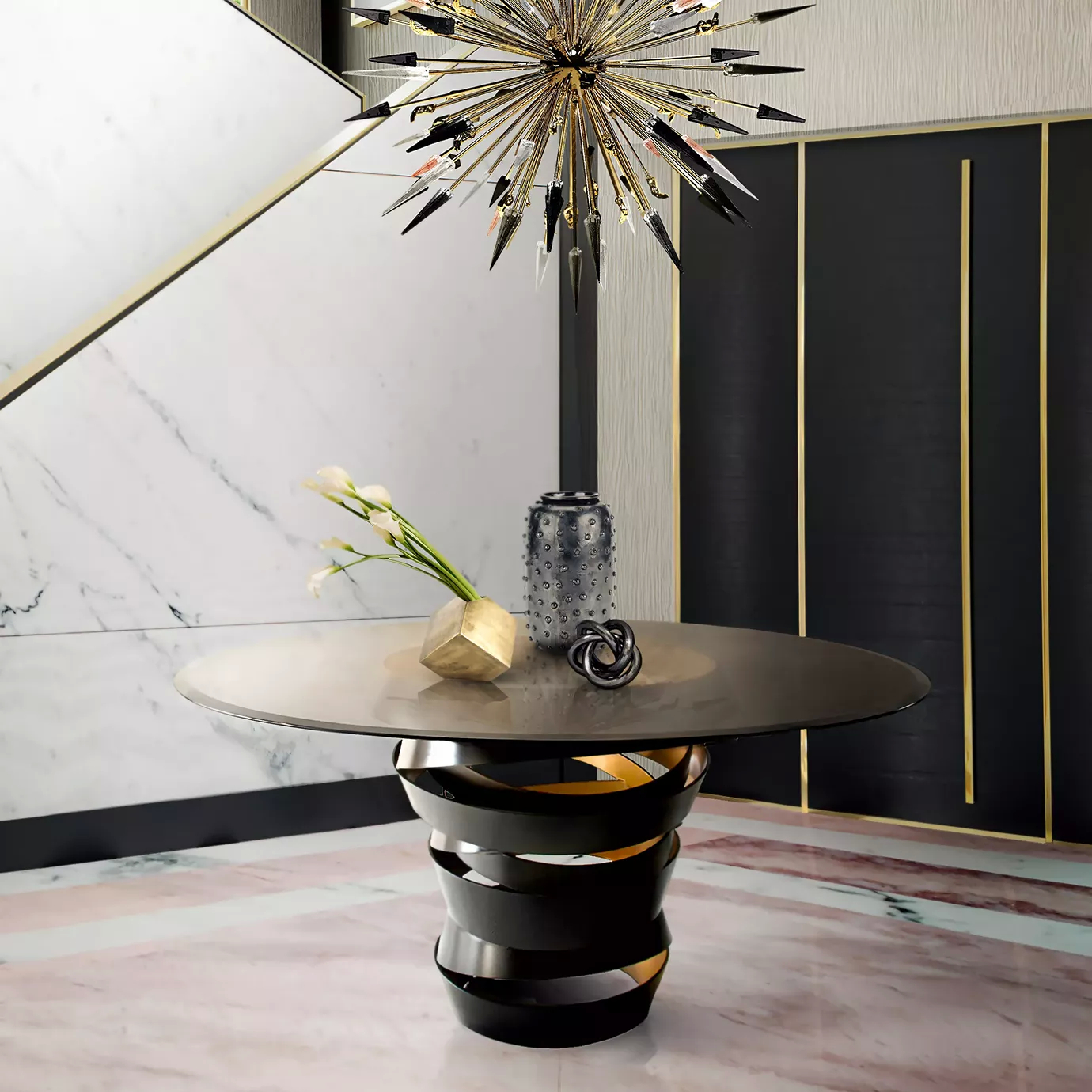 A neutral colored space, with an Intuition Dining Table in the middle. The table has a smoked glass tabletop and a two-tones metal structure, black on the outside and gold on the inside, combining with the door on the background. Above the table here is a black and golden chandelier.