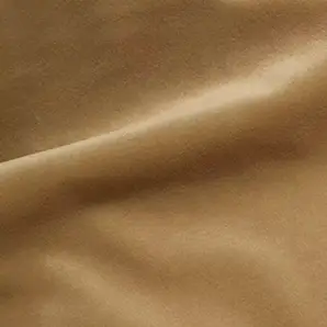 Elegant close-up of a Cozy Velvet fabric swatch in a soft beige tone, showcasing its smooth and slightly lustrous texture with gentle folds.