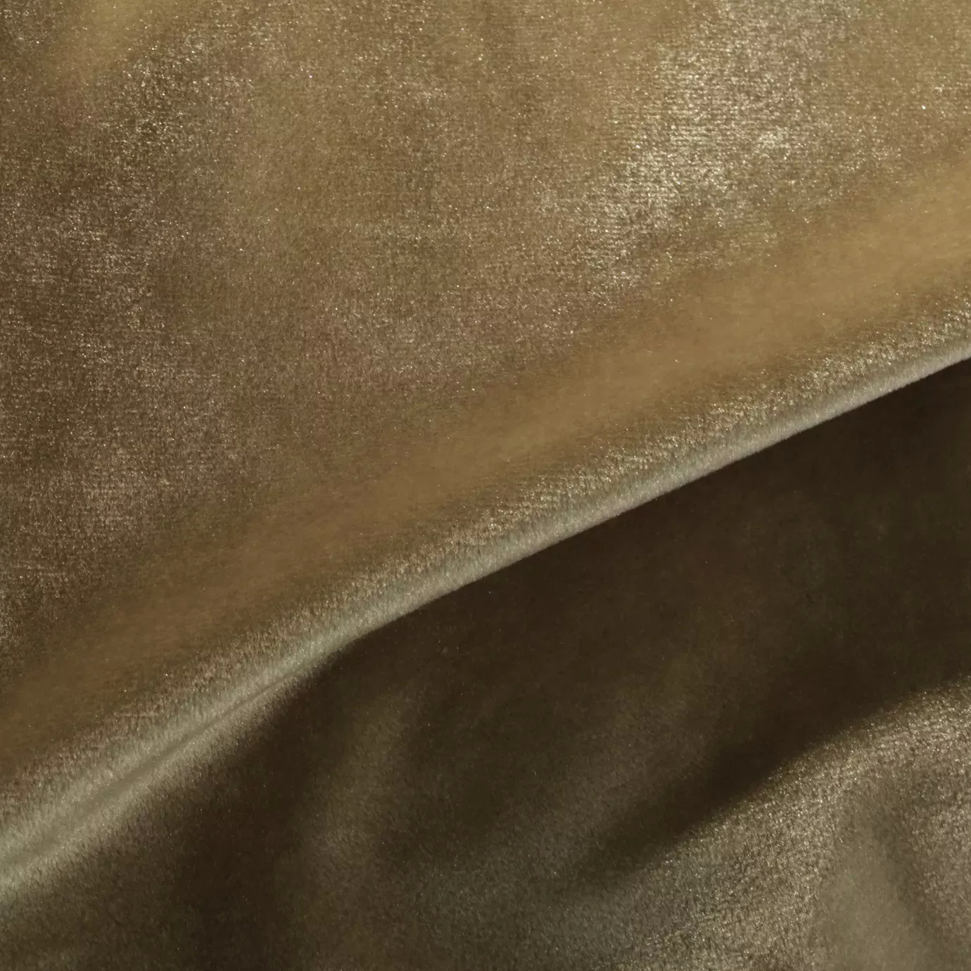 Elegant close-up of a Silky Velvet fabric swatch in a soft and luminous golden tone, showcasing its smooth and shiny texture with gentle folds that highlight its silky sheen.