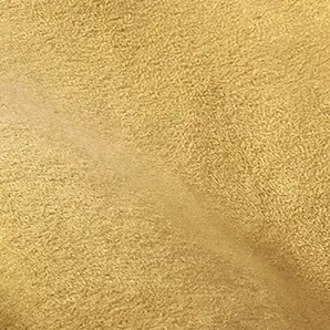 Soft close-up of an Ultra Suede fabric swatch in a warm and natural sandy beige tone, showcasing its soft texture and a delicate touch that gives it a feeling of comfort and casual elegance.