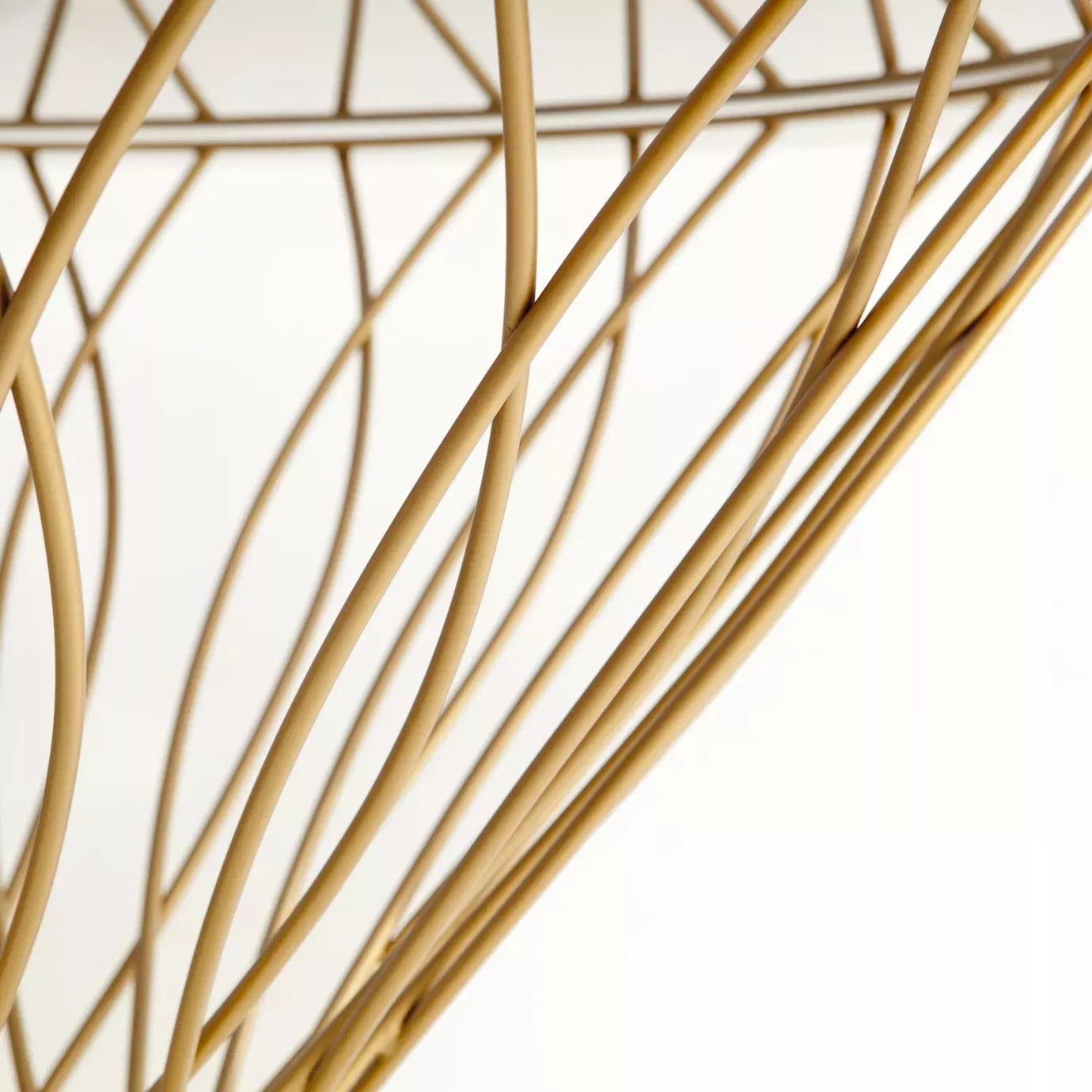 Close up on the Allure Dining Table’s golden silhouette-shaped structure.