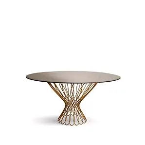 Allure Dining Table: Sophisticated bronze glass top resting on the interlaced golden silhouette-shaped structure.