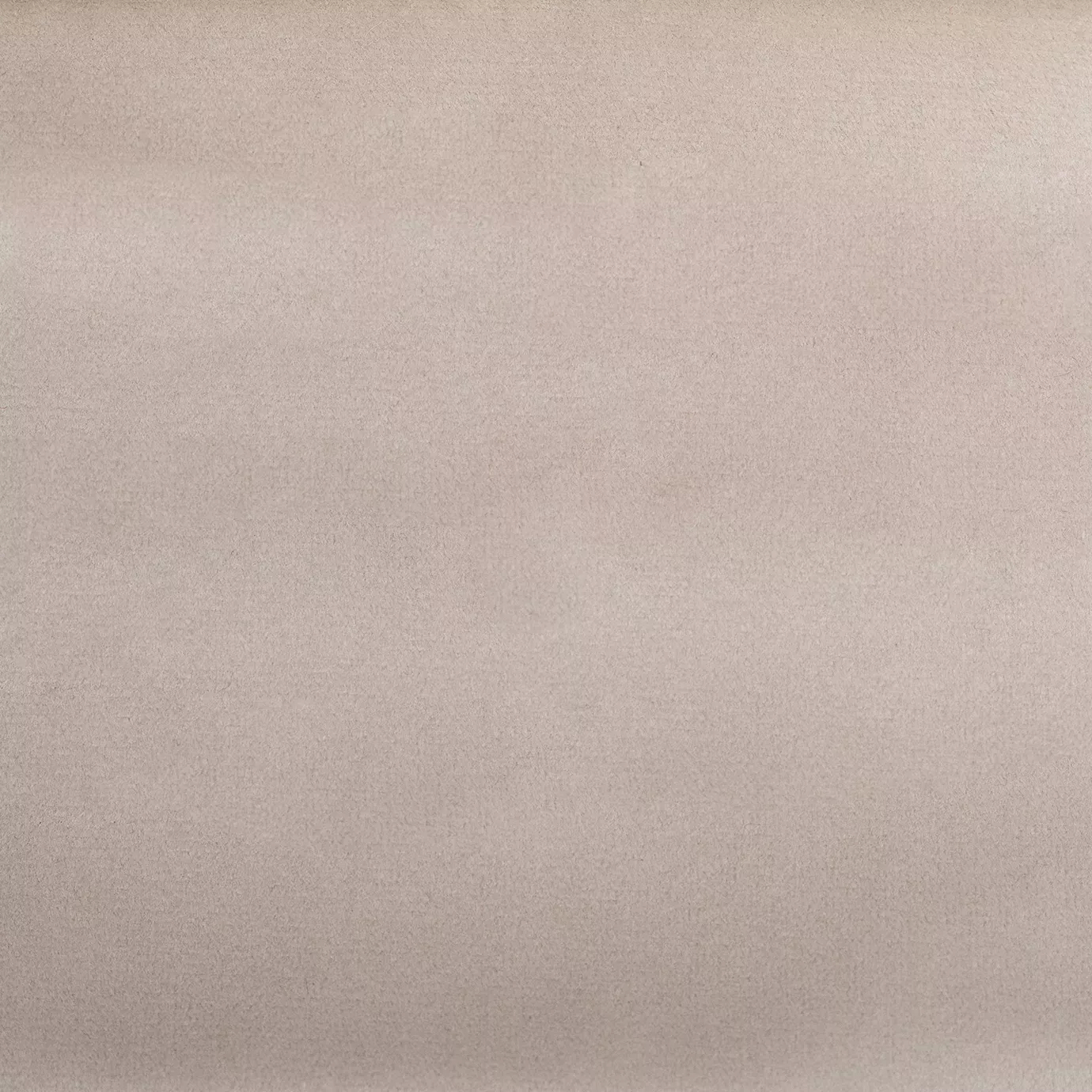 Soft close-up of a Smooth Velvet fabric swatch in a pale and elegant pink tone, showcasing its velvety texture and a gentle sheen that gives it a feeling of sophistication and luxurious comfort.