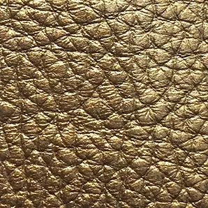Close-up of a Harbor Leather fabric swatch in a textured, aged gold tone, showcasing its raised areas and grooves that give it a rustic and elegant feel. The soft sheen highlights the depth of its texture.