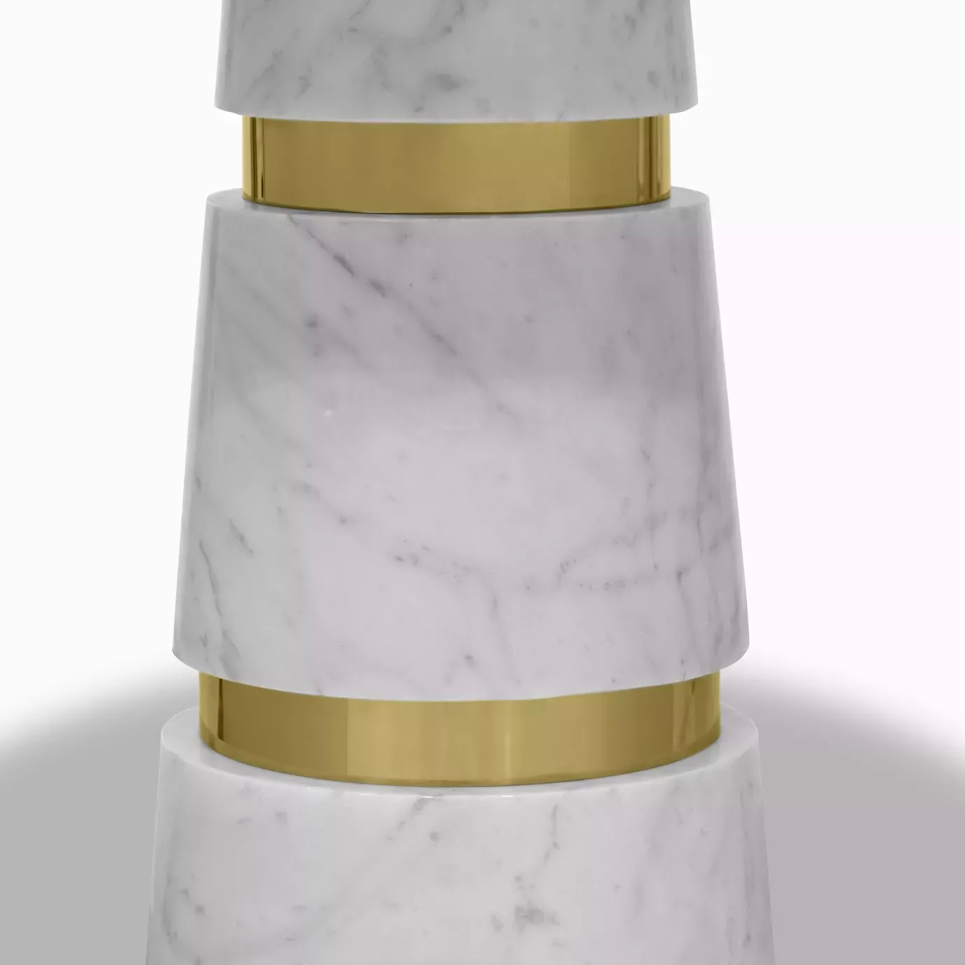 Elegant close-up of the geometric Carrara marble base with golden details of the Avalanche Dining Table.