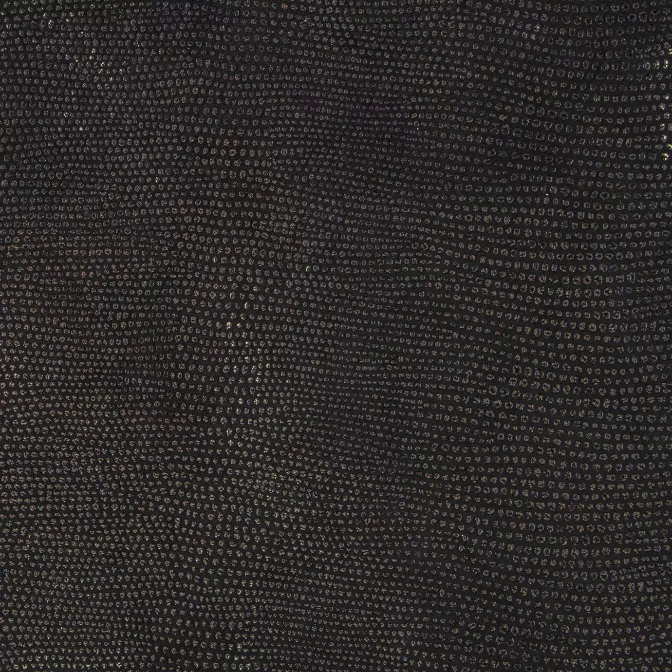 Close-up Pixel Gold Leather: textured black leather with small, shiny golden dots. Flat surface with subtle reflections.