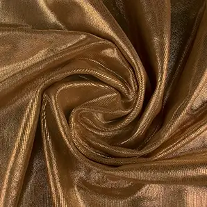 Close-up Salamander Cognac Leather: metallic cognac brown leather with a scaled texture. Features spiraling folds and golden light reflections.