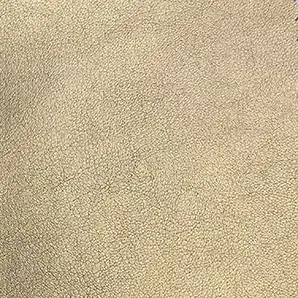 A detailed view of Komodo Synthetic Leather reveals a fine, slightly raised texture with subtle variations in a warm, golden hue.