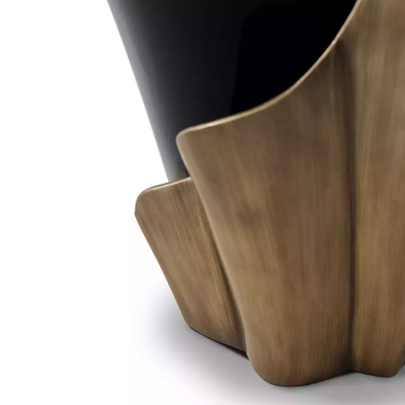 Close look on the base of Yasmine Aged Gold Leaf Side Table’s base, highlighting the aged gold leaf structure around the black solid wooden base.
