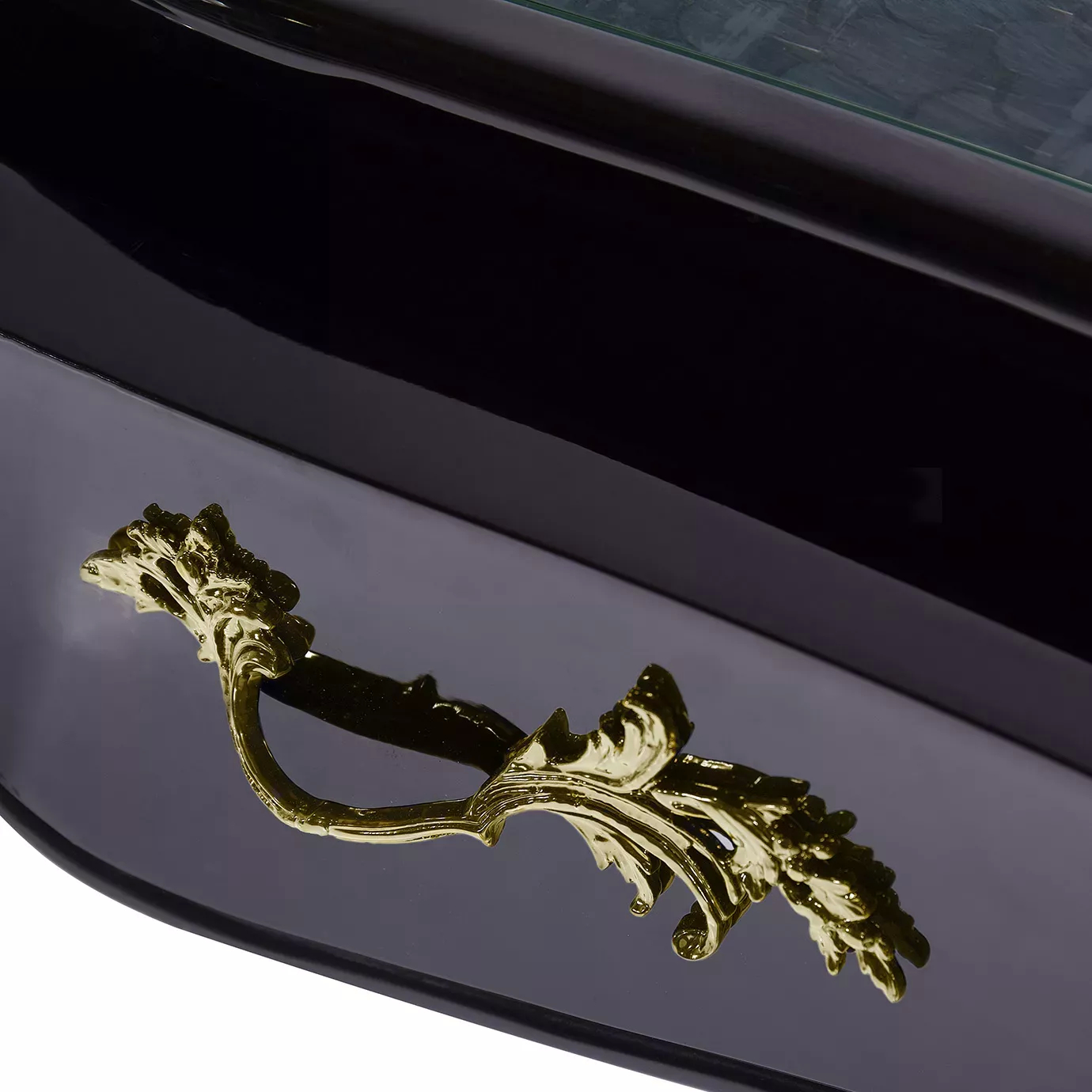Elegant close-up of the ornate golden handle of the black drawer of the Exotic Peacock Feather Top Ormolu Desk.