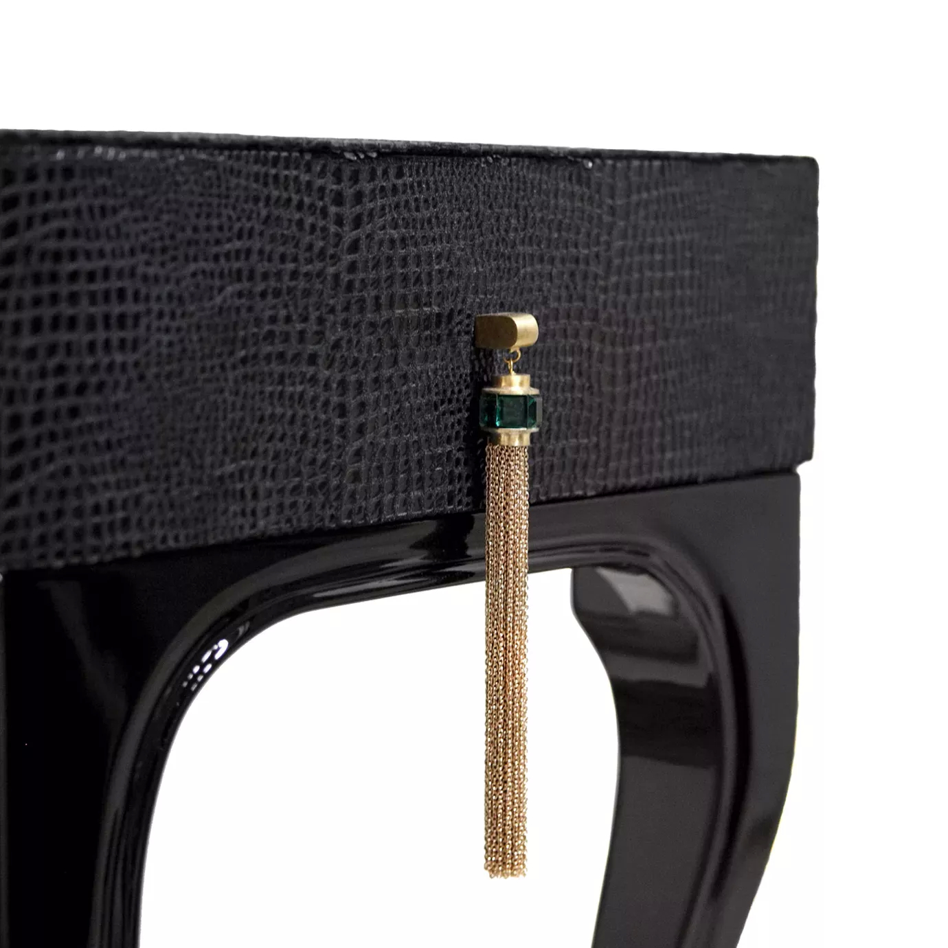 Elegant close-up of the golden handle detail with tassel and emerald of the Exotica Desk.