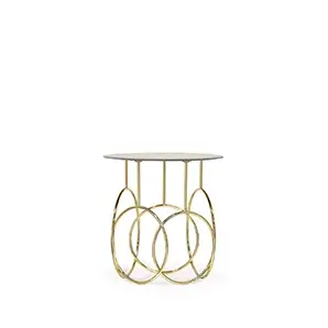 Elegant Kiki Side Table with round top and sculptural golden base.