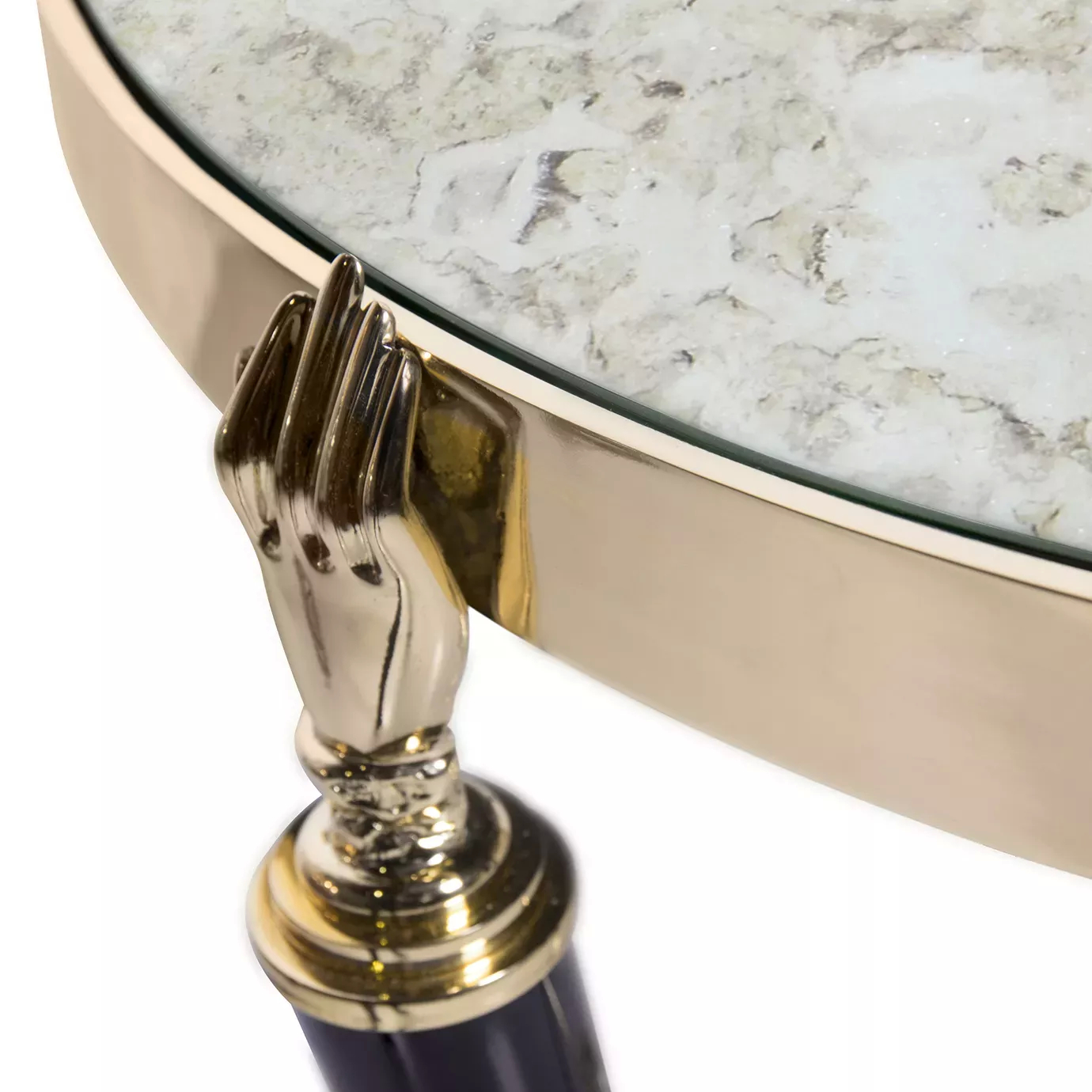 Close-up of the Gisele Side Table, showcasing a shiny gold hand detail connecting to a dark, glossy top with a gold rim.