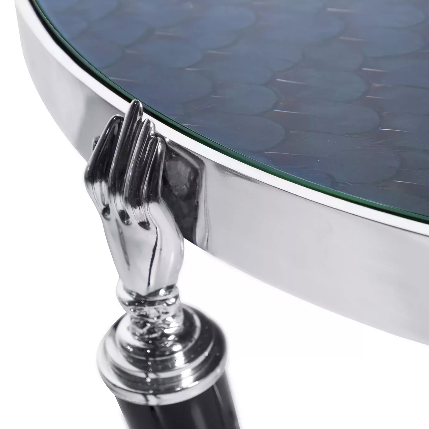 Close-up on the Gisele Nickel Side Table, highlighting a shiny nickel hand detail connecting the leg to the dark, textured top.