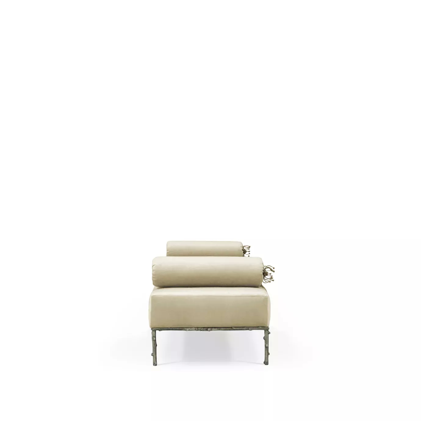 Privê Bench, a cream velvet chaise lounge seen from the end, with decorative bolster pillows and a detailed metal base.