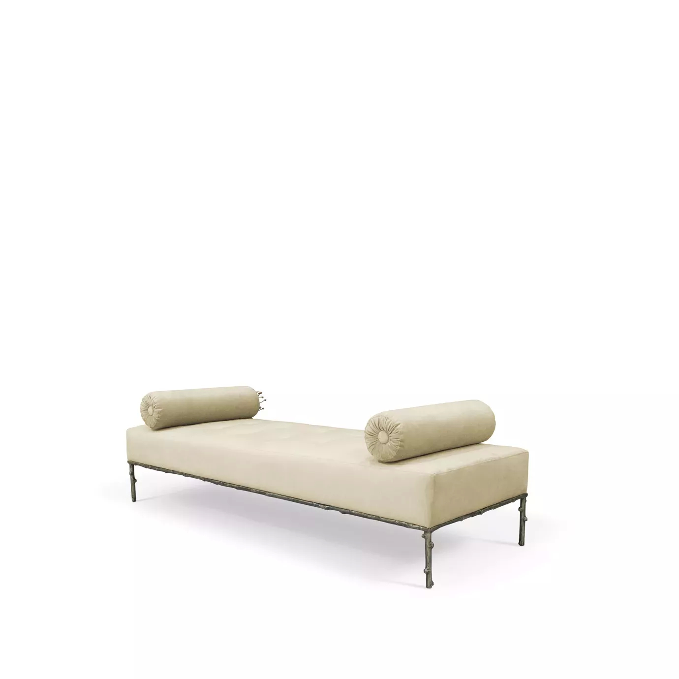 Side view of the Privê Bench, a cream velvet chaise lounge with two bolster pillows and a detailed, dark metal base.