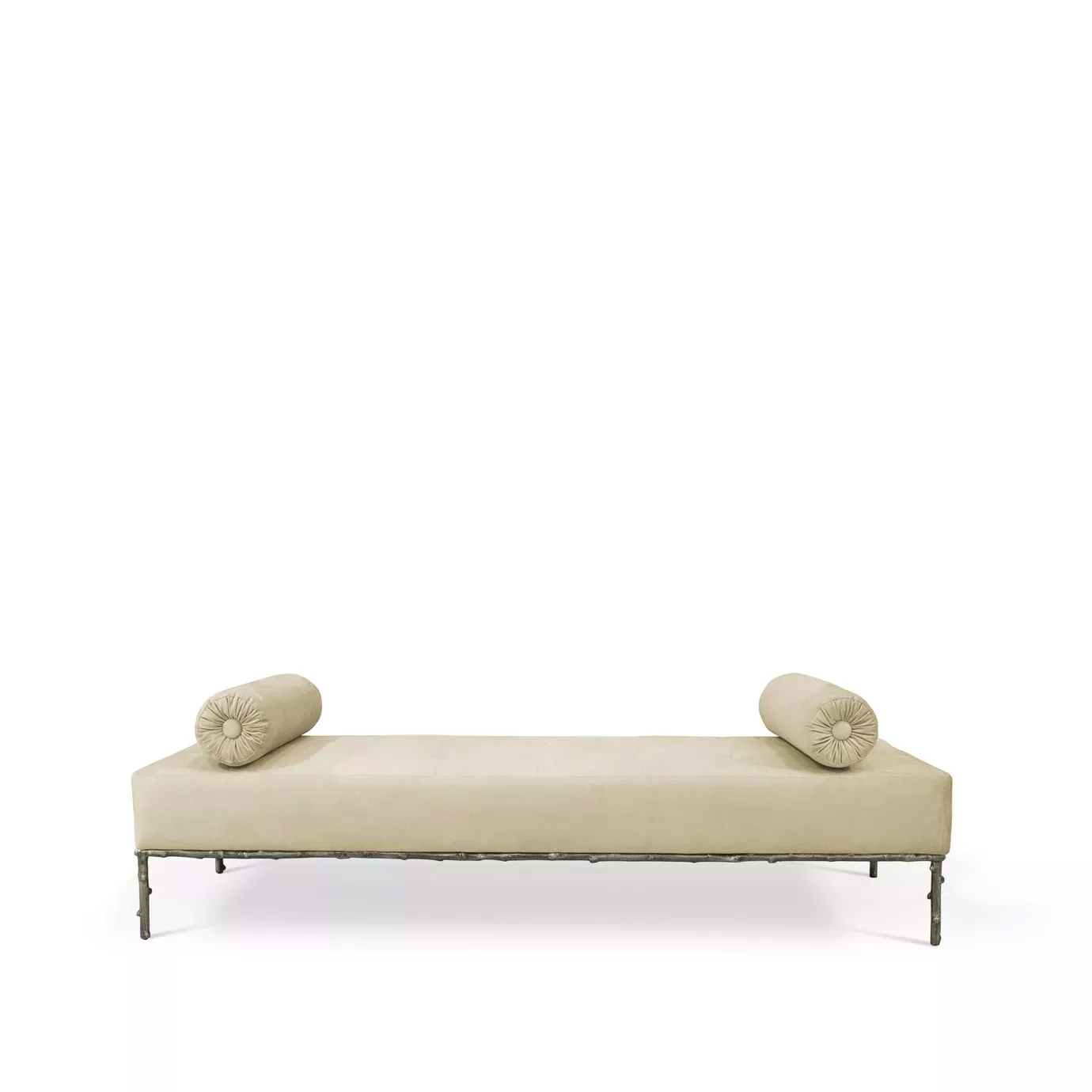 Privê Bench, a cream velvet chaise lounge with two rolled pillows at each end and a detailed, dark metal base.