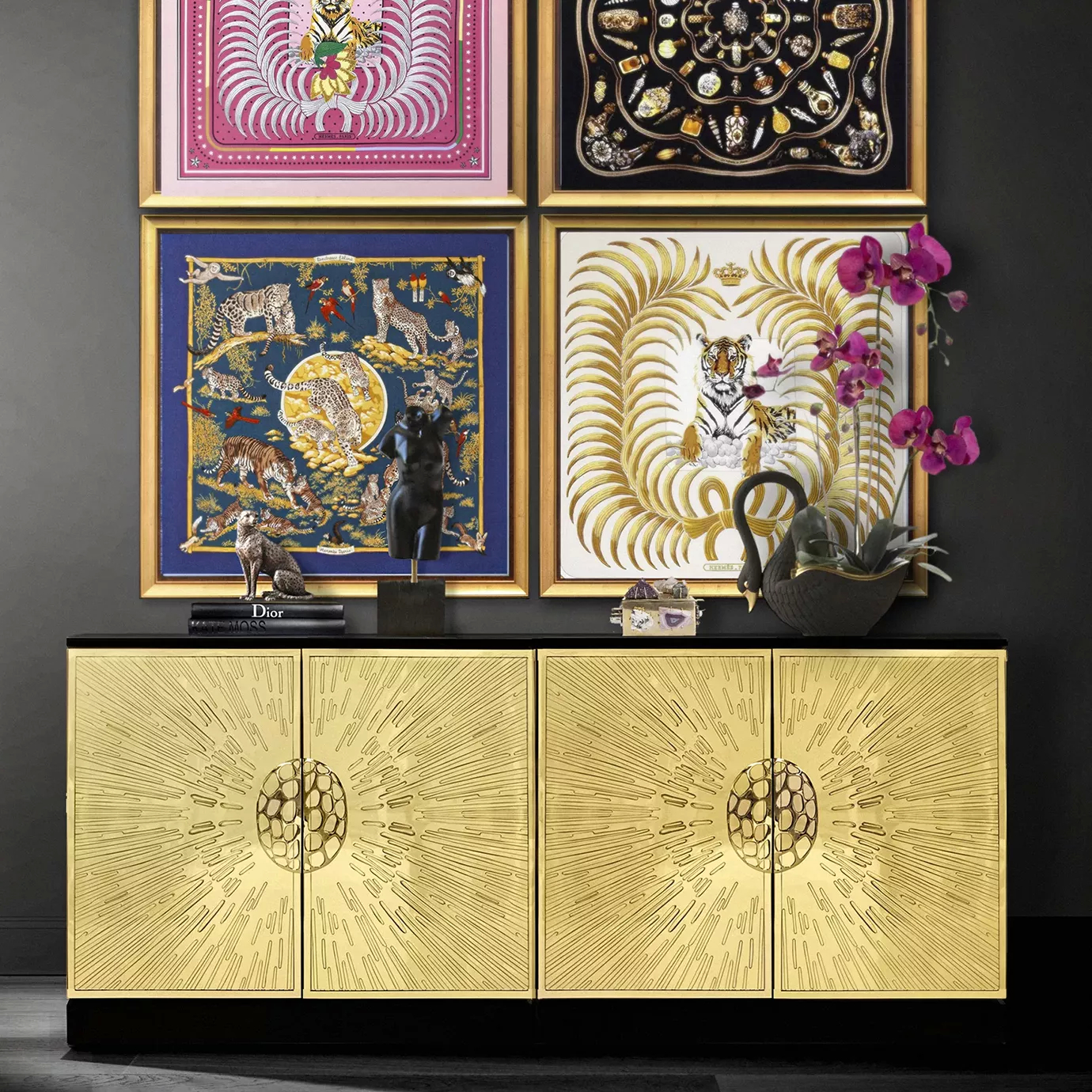 Heive Cabinet in a styled room with golden radiating doors, black top, statues, books, and framed art above.