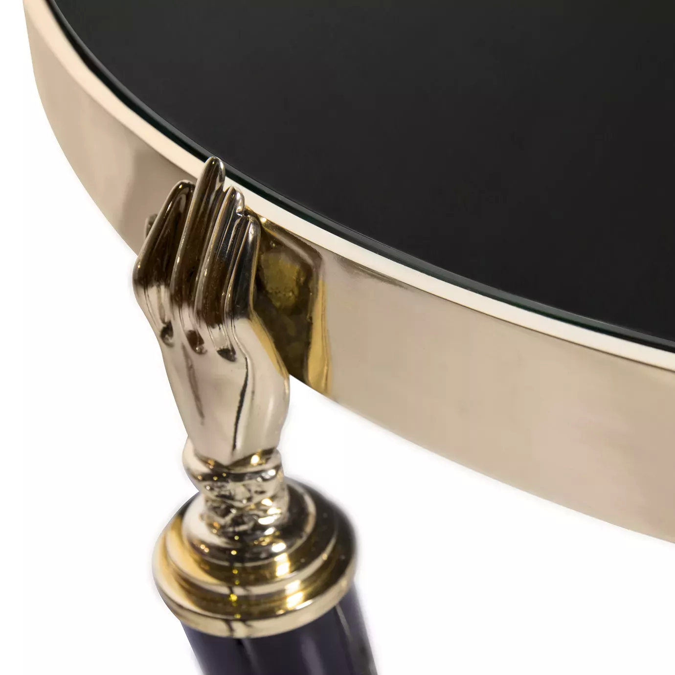 Close-up of the Gisele Lacquer Side Table, focusing on the golden hand detail that connects the black leg to the glossy black tabletop with a golden rim.