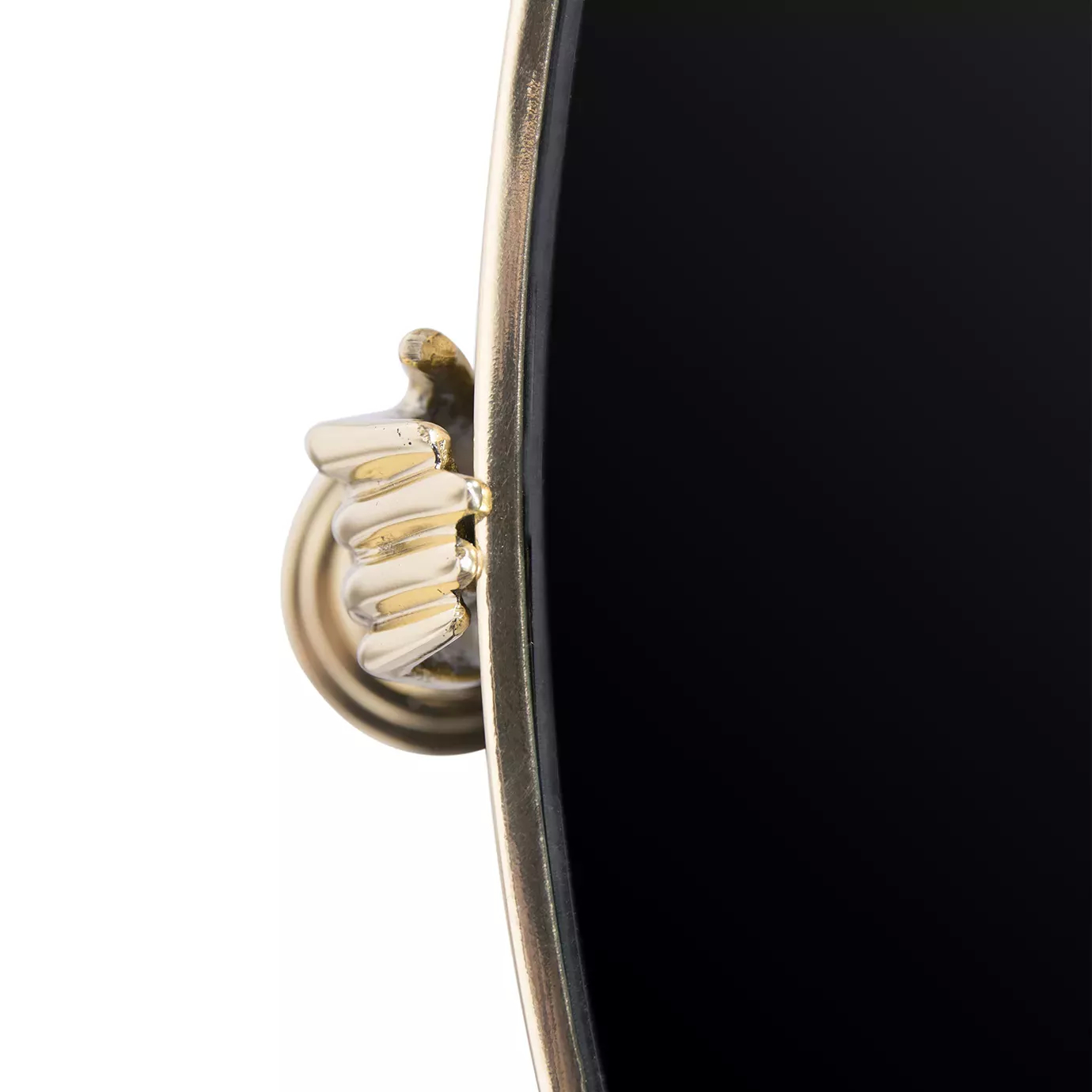 Close-up of the Gisele Lacquer Side Table, showing a golden hand detail holding the edge of the glossy black tabletop with a golden rim.