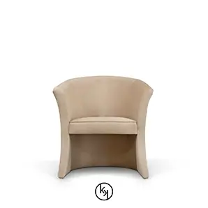 Marseille Chair, a modern armchair with a curved back and continuous, flowing lines, upholstered in a soft, neutral fabric.