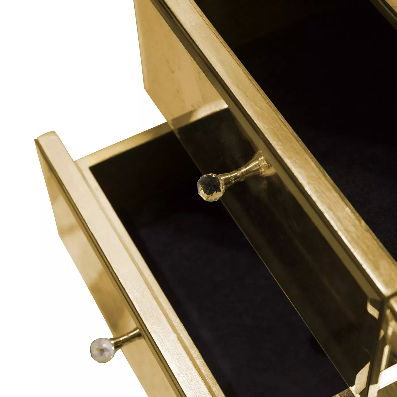 Detail of golden drawers with crystal knobs of the Mademoiselle armoire.
