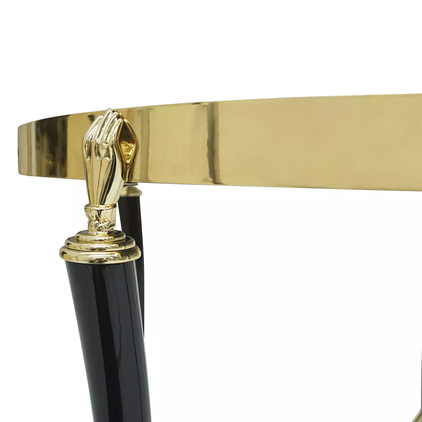 Close-up of the Gisele Table, highlighting the golden hand detail that holds the round tabletop.