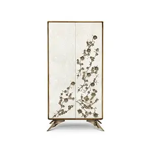 The Spellbound Aged Mirror Armoire features mirrored doors with ornate golden floral details and unique, sculptural golden legs.