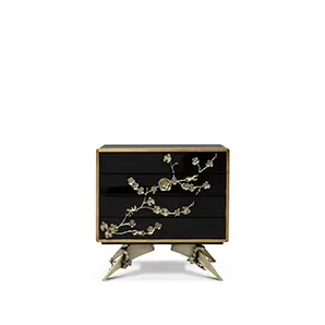 Black lacquer Spellbound Nightstand with ornate golden floral details on drawers and unique, sculptural golden legs.