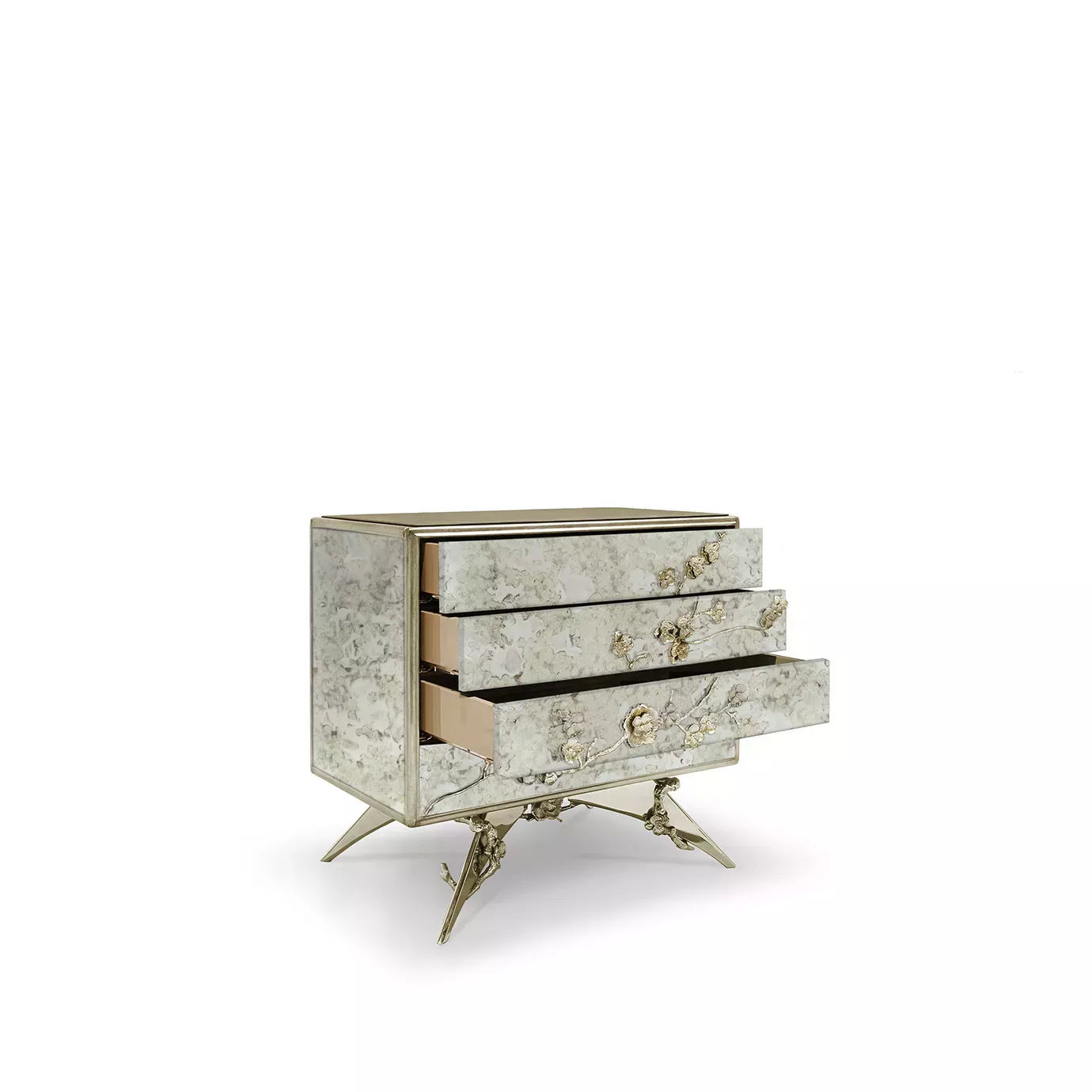 Slight turned view of the Spellbound Aged Mirror Nightstand, showcasing its four drawers, adorned with elegant golden flower-shaped details.