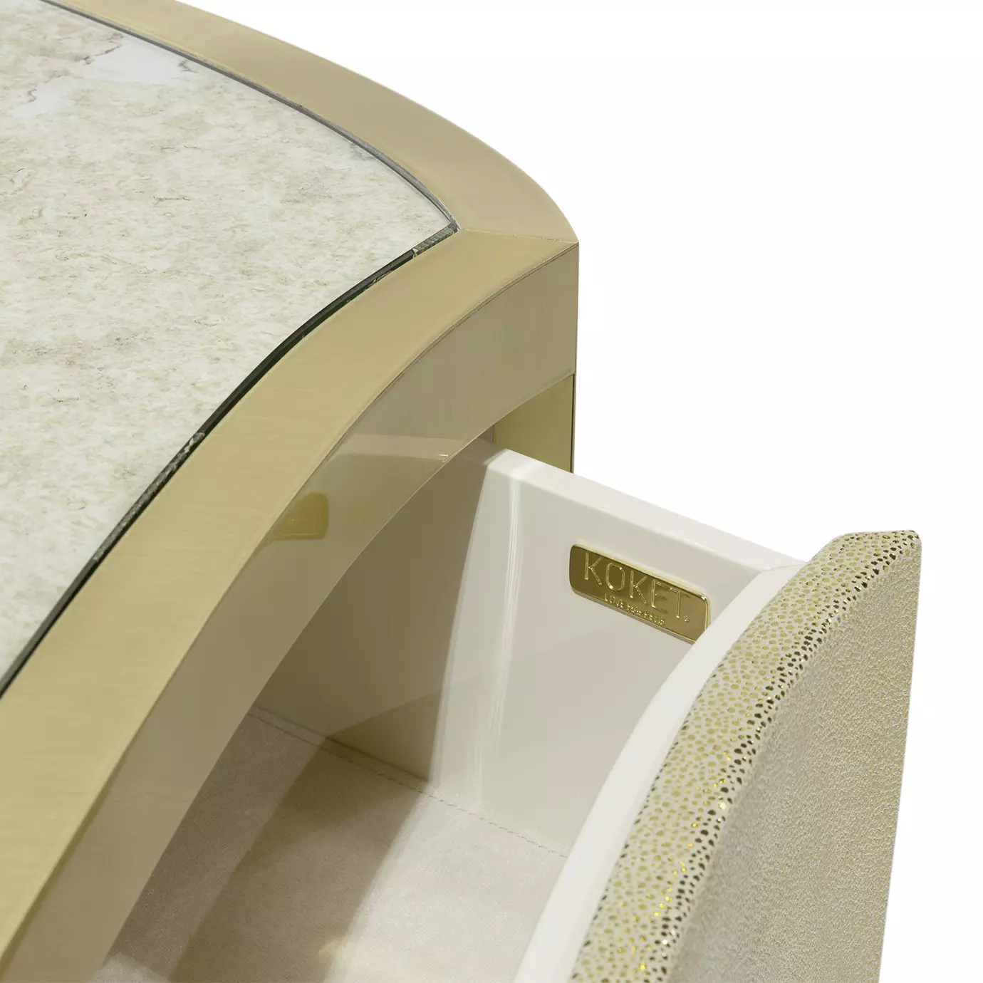 Close-up of the Poêm Chest, showing an open drawer with a "KOKET Love Happens" plaque and the textured golden drawer front.