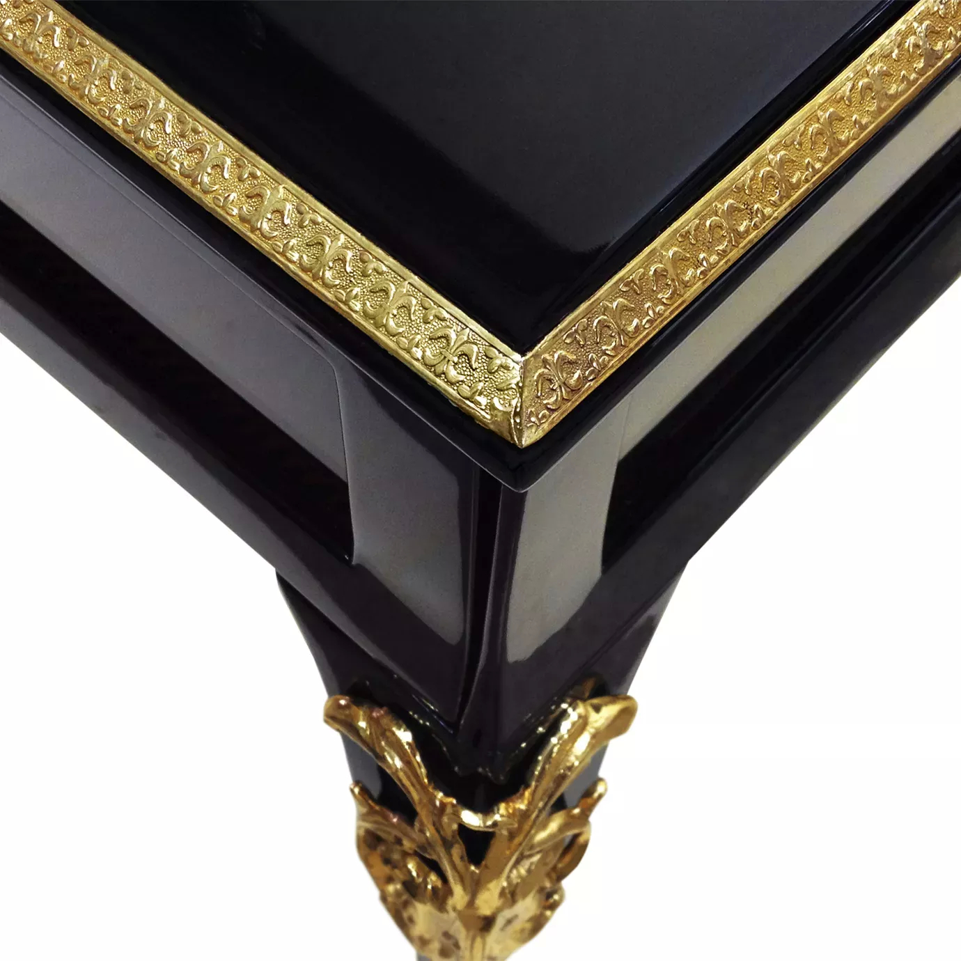 Elegant close-up of the black top with ornate golden details and golden leg of the Cabriole Nightstand.
