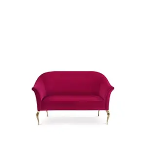 Front view of the Mimi Sofa, showcasing its elegant, curved silhouette and rich, deep-red velvet upholstery.