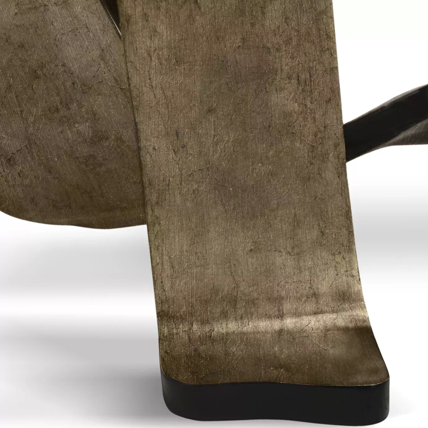 Close-up on the base of the Ribbon Broken Silver Leaf Dining Table, highlighting the textured silver leaf and dark trim.