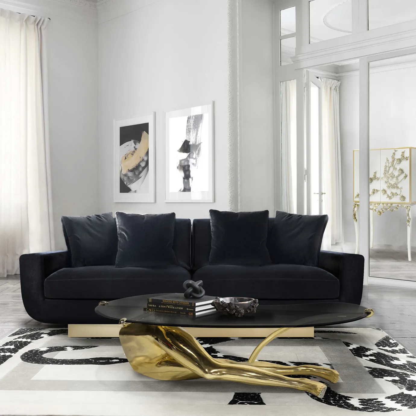 Tabu Polished Brass Coffee Table in a modern living room, featuring a sleek glass top and human-like base in polished brass, styled with books and decor.
