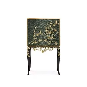 The Spellbound Peacock Feather Bar Cabinet’s structure is adorned with greenish peacock feathers ornamented with elegant golden flower-shaped details elongating to its black base.