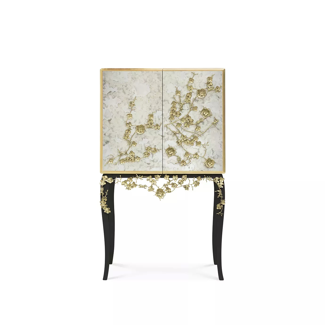 The Spellbound Aged Mirror Bar Cabinet features an elegant golden frame and golden flower-shaped details on its door elongating to its black base.