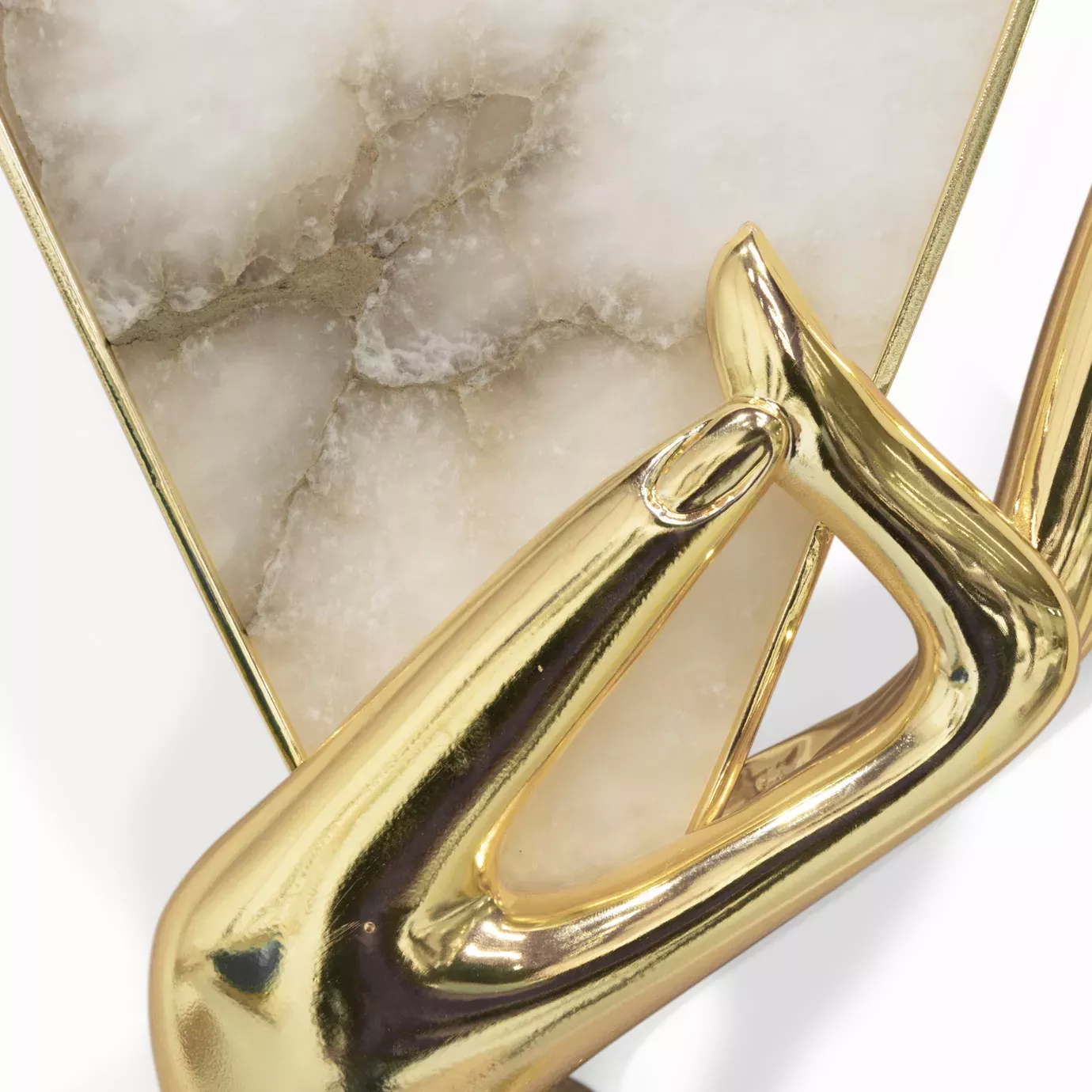 Close-up of the Muse Alabaster Sconce, highlighting its gold hand and alabaster shade with intricate details.