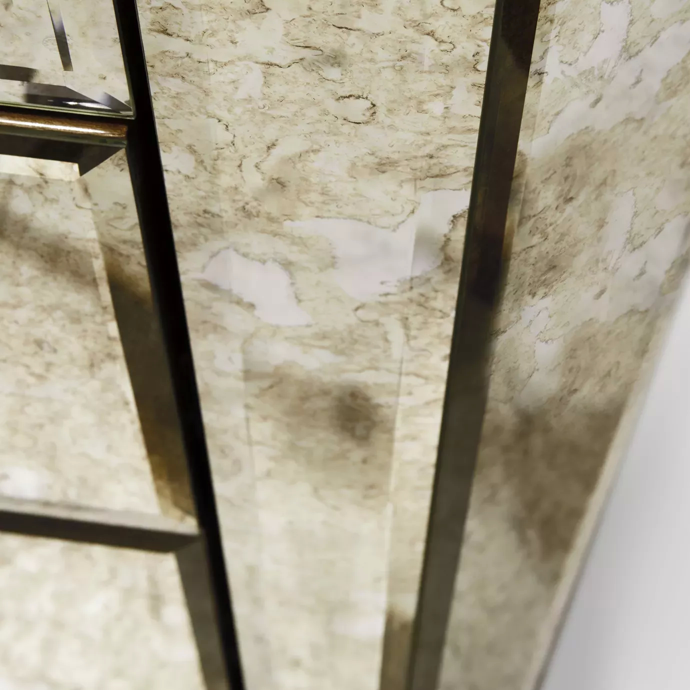 Close-up of the Tamara Chest, showcasing its mirrored panel with a unique antique finish and metallic trim detail.