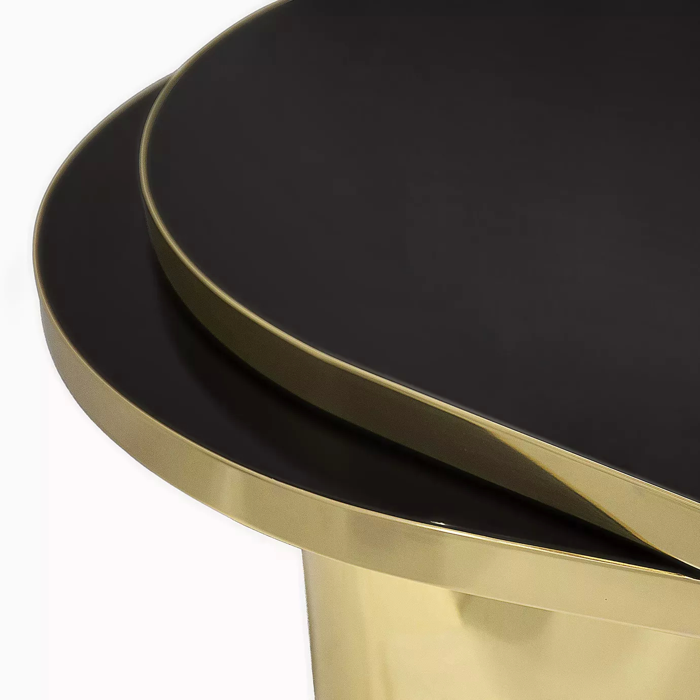 Detail of the two-tiered black top of the elegant Tears coffee table in polished brass.